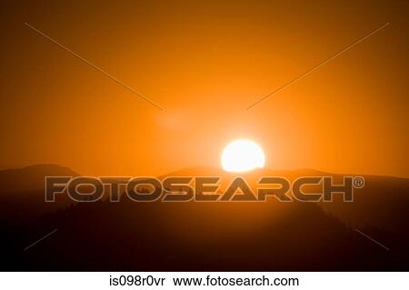 Sun rising over a mountain View Large Photo Image Stock Photography - Sun rising over a mountain. Fotosearch