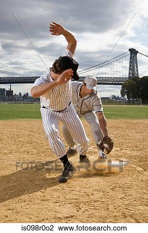 Stock Image - Two men playing baseball game. Fotosearch