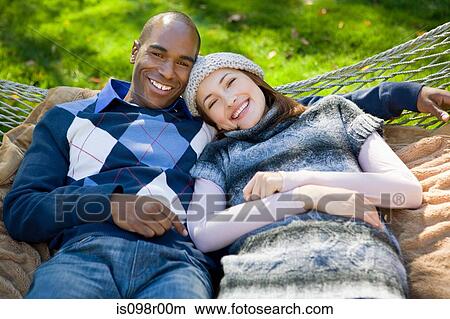 Picture - Young couple on hammock. Fotosearch
