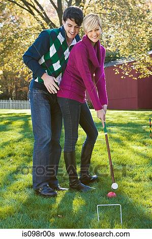 Young couple playing croquet View Large Photo Image Stock Photograph - Young couple playing croquet. Fotosearch