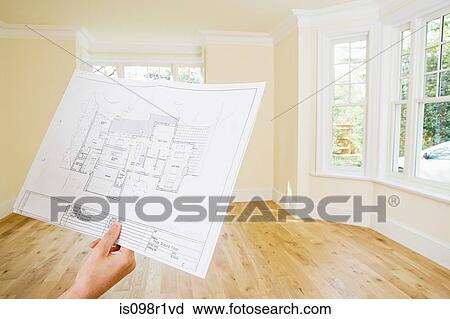 Young woman holding a blueprint View Large Photo Image Stock Image - Young woman holding a blueprint. Fotosearch