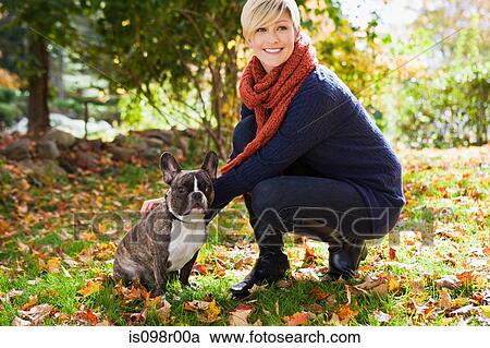 Stock Image - Young woman with pet dog. Fotosearch