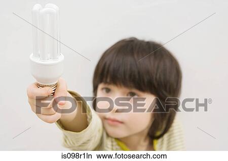 A boy holding a lightbulb View Large Photo Image Picture - A boy holding a lightbulb. Fotosearch
