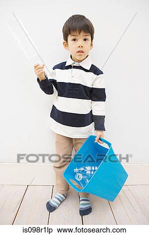 A boy holding a recycling bin View Large Photo Image Stock Photography - A boy holding a recycling bin. Fotosearch