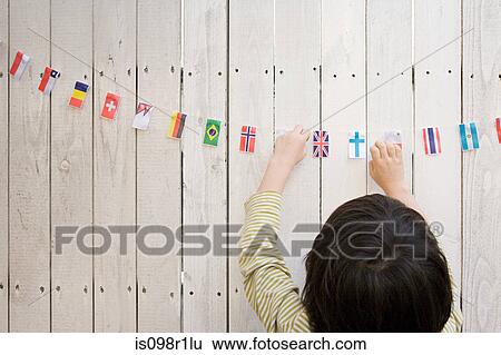 A boy reaching flags View Large Photo Image Stock Photograph - A boy reaching flags. Fotosearch