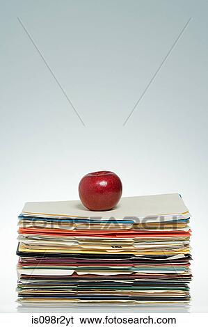 Stock Photograph - Apple on files. Fotosearch