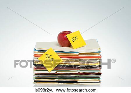 Apple on files View Large Photo Image Stock Photograph - Apple on files. Fotosearch