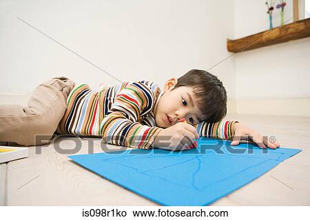 Boy holding a crayon View Large Photo Image Picture - Boy holding a crayon. Fotosearch