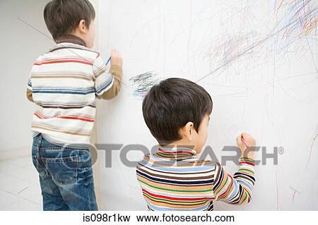 Stock Photo - Boys drawing on a wall. Fotosearch