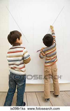 Stock Photograph - Boys drawing on a wall. Fotosearch