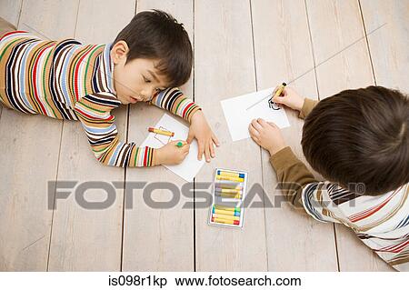 Stock Photography - Boys drawing with crayons. Fotosearch