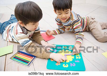 Boys playing with a clock View Large Photo Image Stock Photography - Boys playing with a clock. Fotosearch