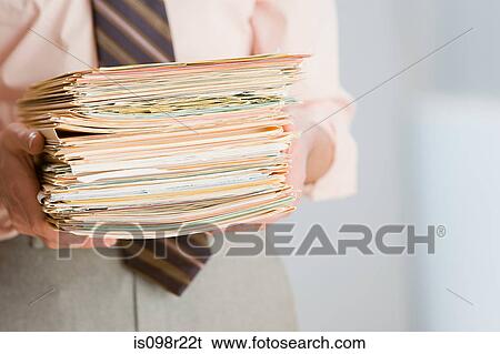 Businessman with paperwork View Large Photo Image Stock Photograph - Businessman with paperwork. Fotosearch