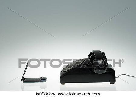 Cellphone and old fashioned telephone View Large Photo Image Stock Photo - Cellphone and old fashioned telephone. Fotosearch