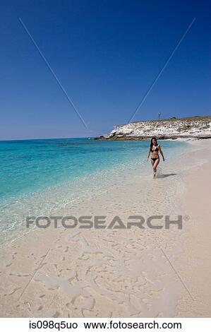 Girl walking in surf. View Large Photo Image Picture - Girl walking in surf.. Fotosearch