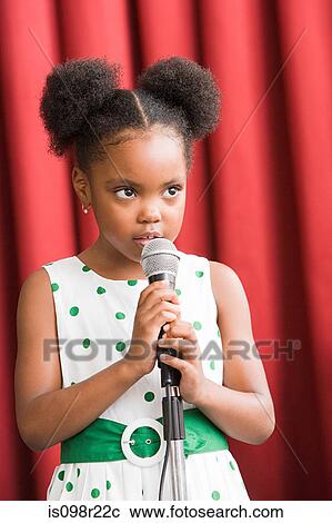 Stock Image - Girl with microphone. Fotosearch