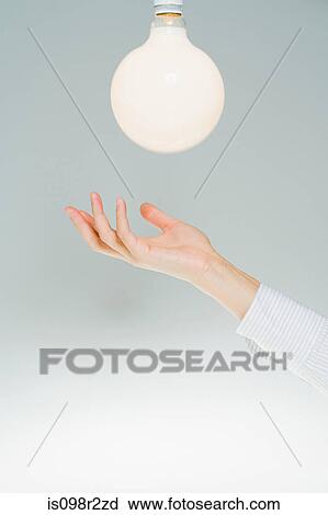 Hand and lightbulb View Large Photo Image Stock Image - Hand and lightbulb. Fotosearch