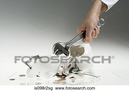 Person smashing piggy bank View Large Photo Image Stock Image - Person smashing piggy bank. Fotosearch