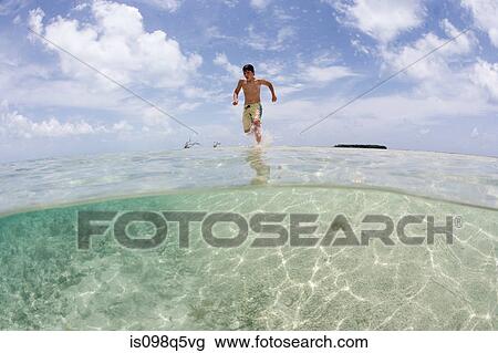 Running through surf. View Large Photo Image Stock Image - Running through surf.. Fotosearch