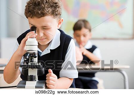 Stock Image - Schoolboy with microscope. Fotosearch