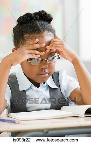 Schoolgirl looking at book View Large Photo Image Stock Image - Schoolgirl looking at book. Fotosearch