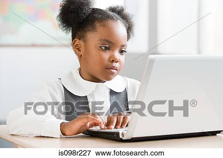 Schoolgirl using laptop View Large Photo Image Stock Photo - Schoolgirl using laptop. Fotosearch