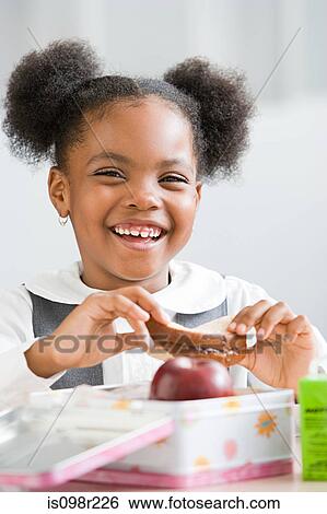 Stock Photograph - Schoolgirl with packed lunch. Fotosearch