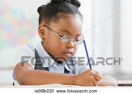 Stock Image - Schoolgirl writing. Fotosearch