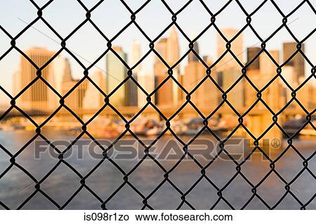 Picture - Skyscrapers behind a wire fence. Fotosearch