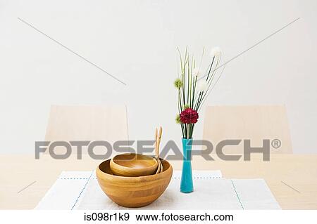 Vase of flowers and bowls on a table View Large Photo Image Stock Photo - Vase of flowers and bowls on a table. Fotosearch
