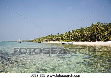 Beautiful beach with boats in the water View Large Photo Image Stock Photograph - Beautiful beach with boats in the water. Fotosearch