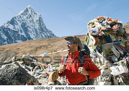 Stock Photo - Man mountaineering in the himalayas. Fotosearch