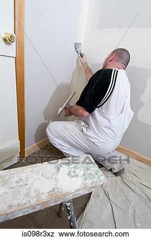 Stock Photo - Plasterer working on walls. Fotosearch