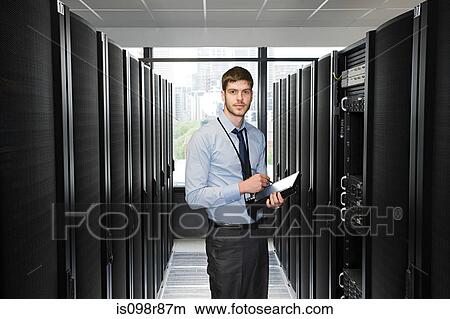 Computer technician working on a server View Large Photo Image Picture - Computer technician working on a server. Fotosearch