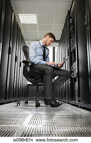 Computer technician working on a server View Large Photo Image Picture - Computer technician working on a server. Fotosearch