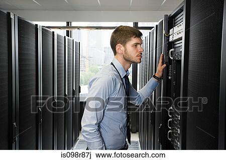 Computer technician working on a server View Large Photo Image Stock Image - Computer technician working on a server. Fotosearch