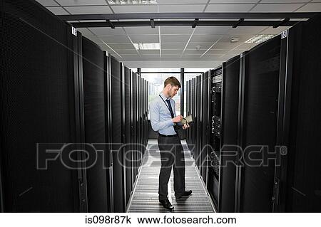 Computer technician working on a server View Large Photo Image Stock Image - Computer technician working on a server. Fotosearch