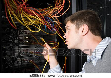 Computer technician working on a server View Large Photo Image Stock Photograph - Computer technician working on a server. Fotosearch