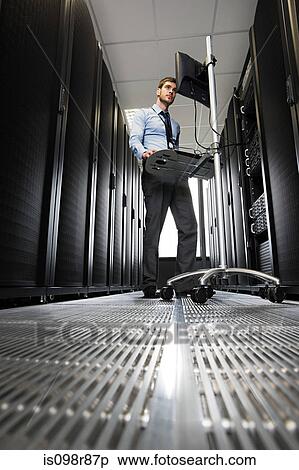 Computer technician working on a server View Large Photo Image Stock Photography - Computer technician working on a server. Fotosearch