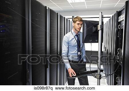 Computer technician working on a server View Large Photo Image Stock Photography - Computer technician working on a server. Fotosearch