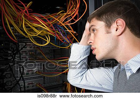 Confused looking computer technician View Large Photo Image Stock Photography - Confused looking computer technician. Fotosearch