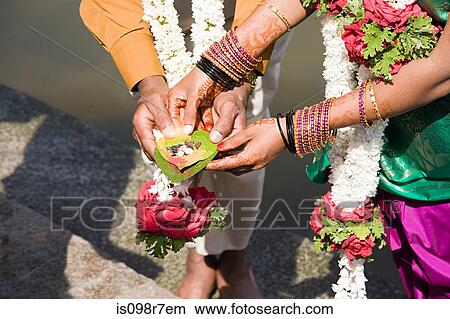 Couple holding puja in indian wedding ceremony View Large Photo Image Picture - Couple holding puja in indian wedding ceremony. Fotosearch