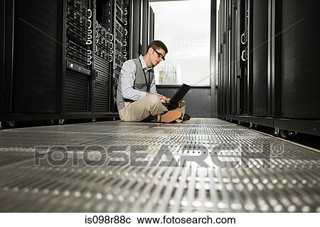 Stock Image - Male computer technician working. Fotosearch