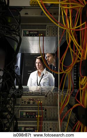 Two computer technicians and a network server View Large Photo Image Stock Photograph - Two computer technicians and a network server. Fotosearch