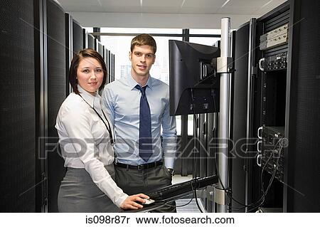 Two computer technicians working on a server View Large Photo Image Stock Photography - Two computer technicians working on a server. Fotosearch