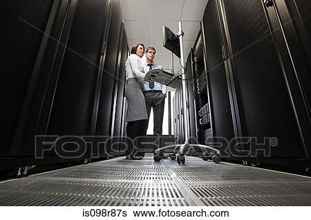 Two computer technicians working on servers View Large Photo Image Stock Photograph - Two computer technicians working on servers. Fotosearch