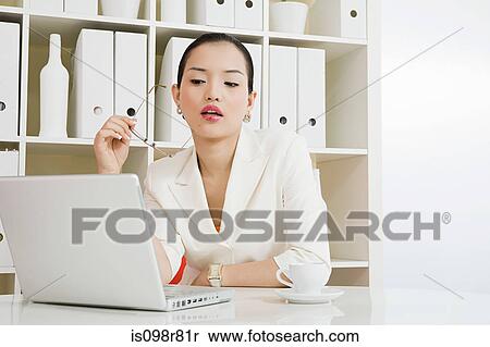 Young woman in white office View Large Photo Image Stock Photography - Young woman in white office. Fotosearch