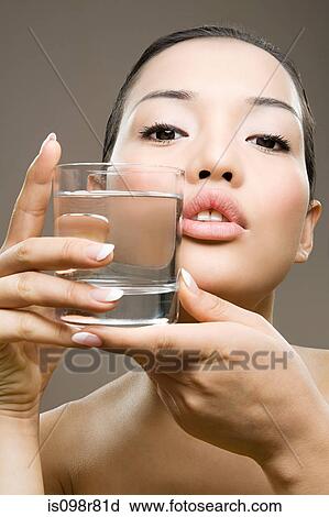 Stock Image - Young woman with glass of water. Fotosearch