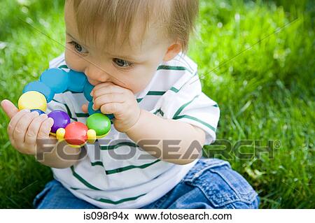 Baby with a teething ring View Large Photo Image Stock Photo - Baby with a teething ring. Fotosearch