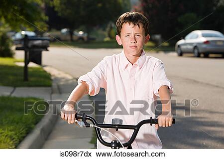 Boy with bicycle in suburban setting View Large Photo Image Stock Photo - Boy with bicycle in suburban setting. Fotosearch